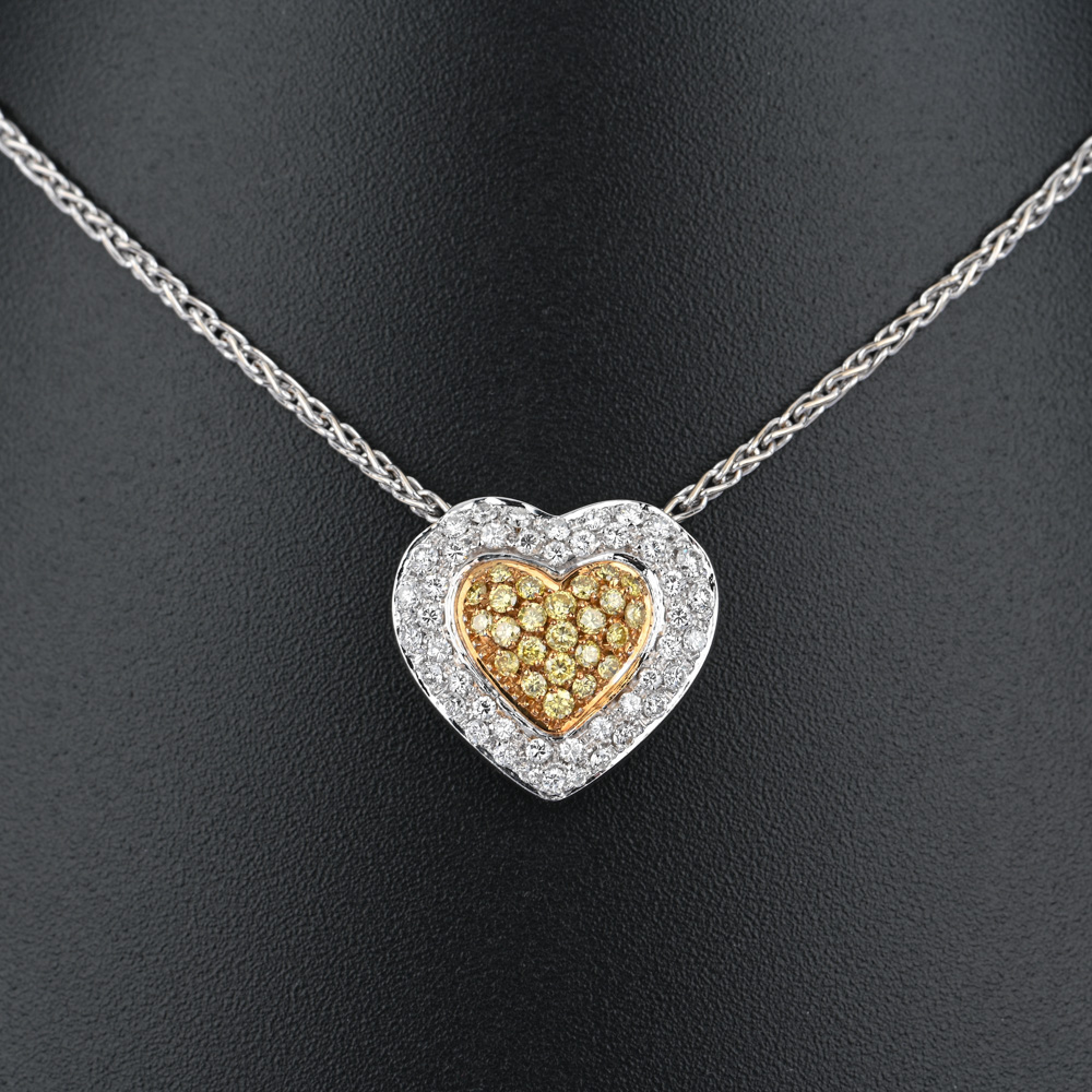 Collier mit Herz-Anhänger, 45 Brillanten ca. 0,70 ct, 24 gelbe Brillanten (beh.) ca. 0,24 ct, BiC750 ca. 12,6 g, Länge: 43,5 cm